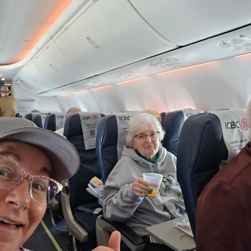 On the charter flight.